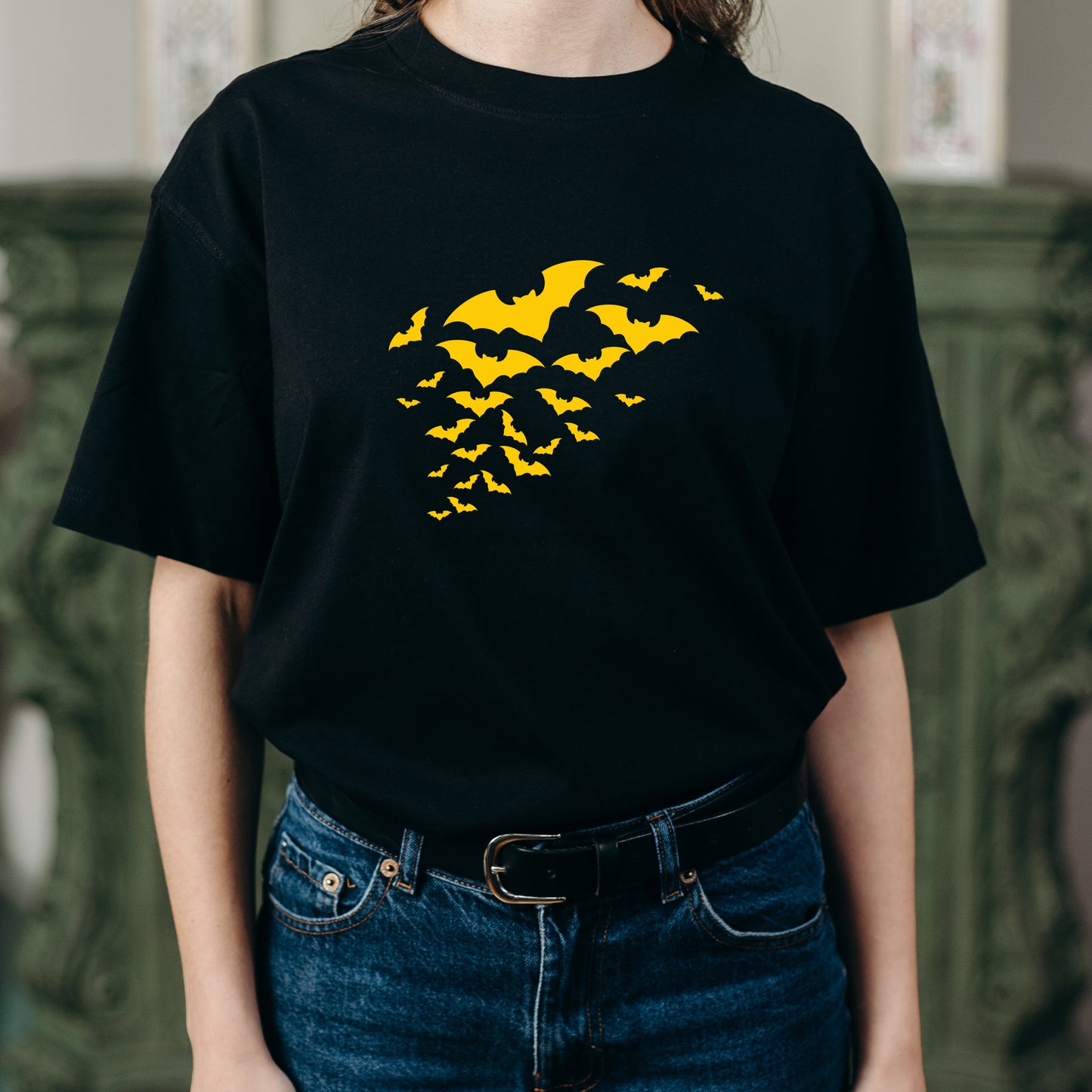Silhouetted flock of bats soaring through the night sky