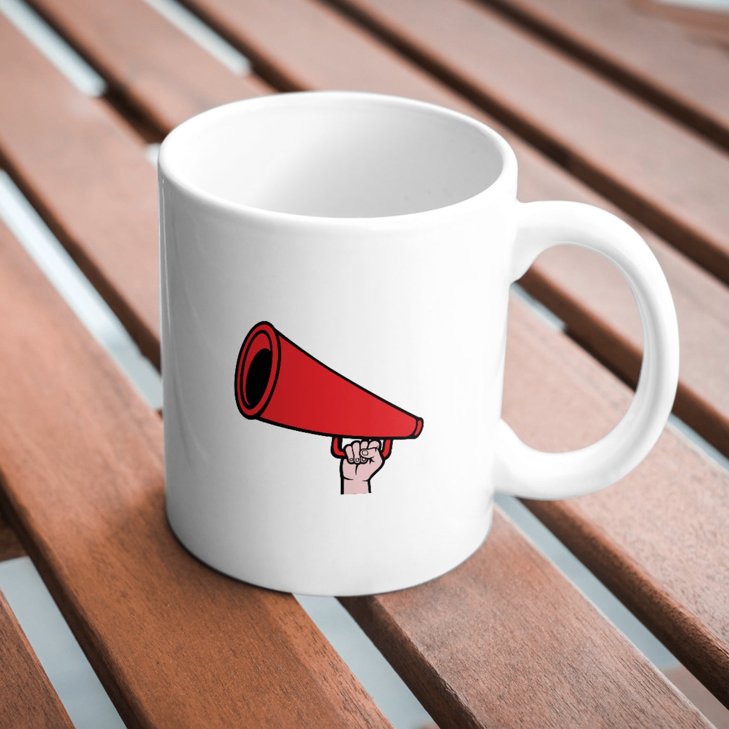 Creative hand holding a red megaphone for expression