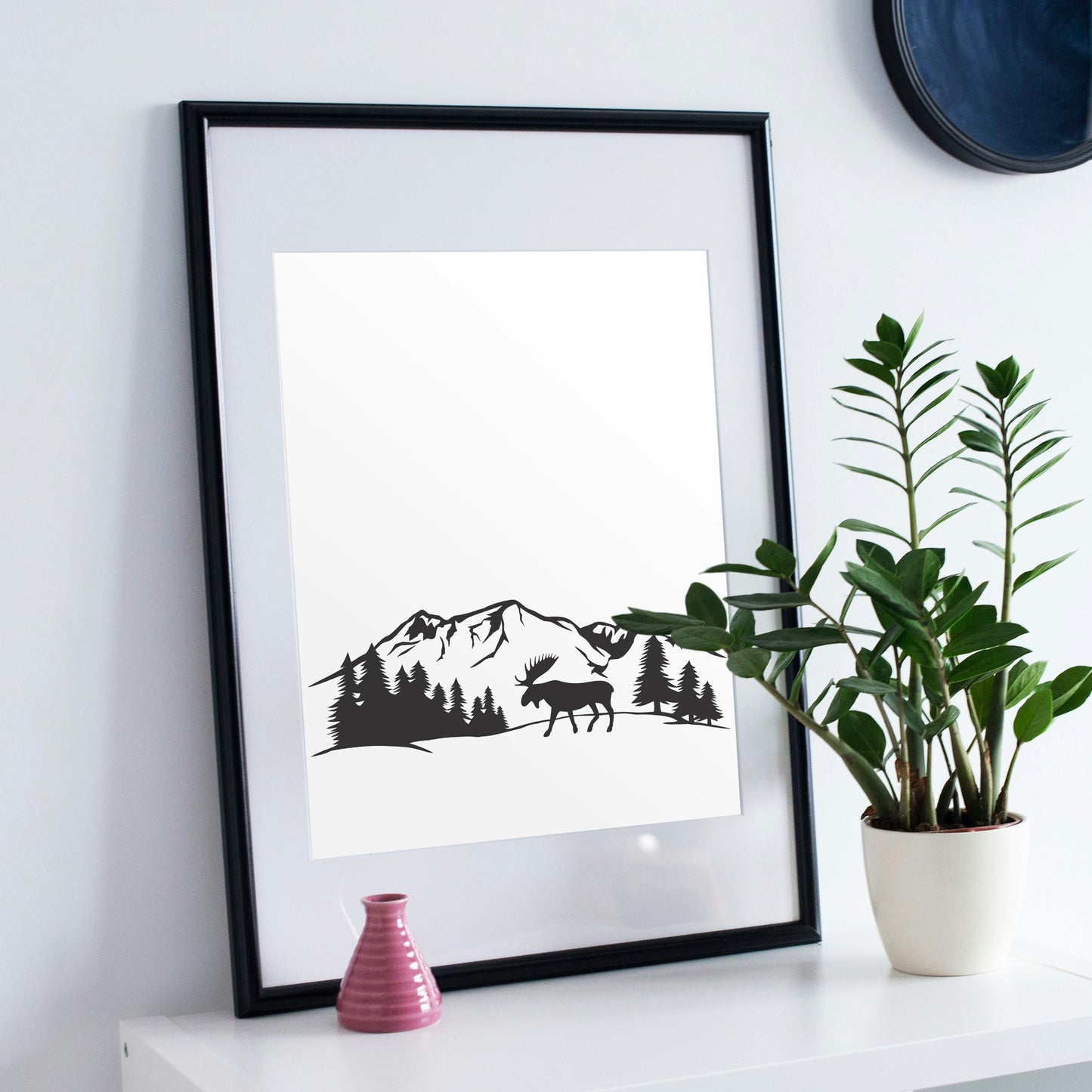 Majestic moose wandering through serene mountain landscape
