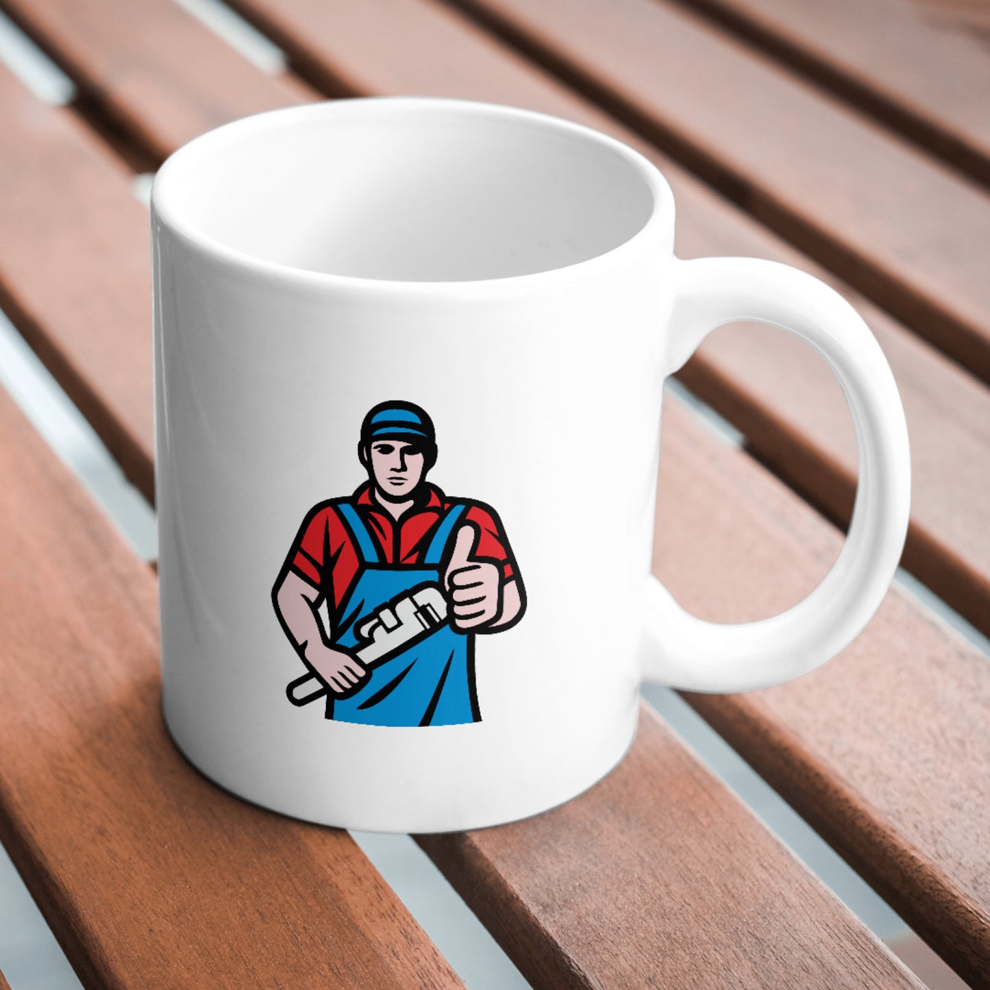 Plumber holding a wrench ready for action in workshop