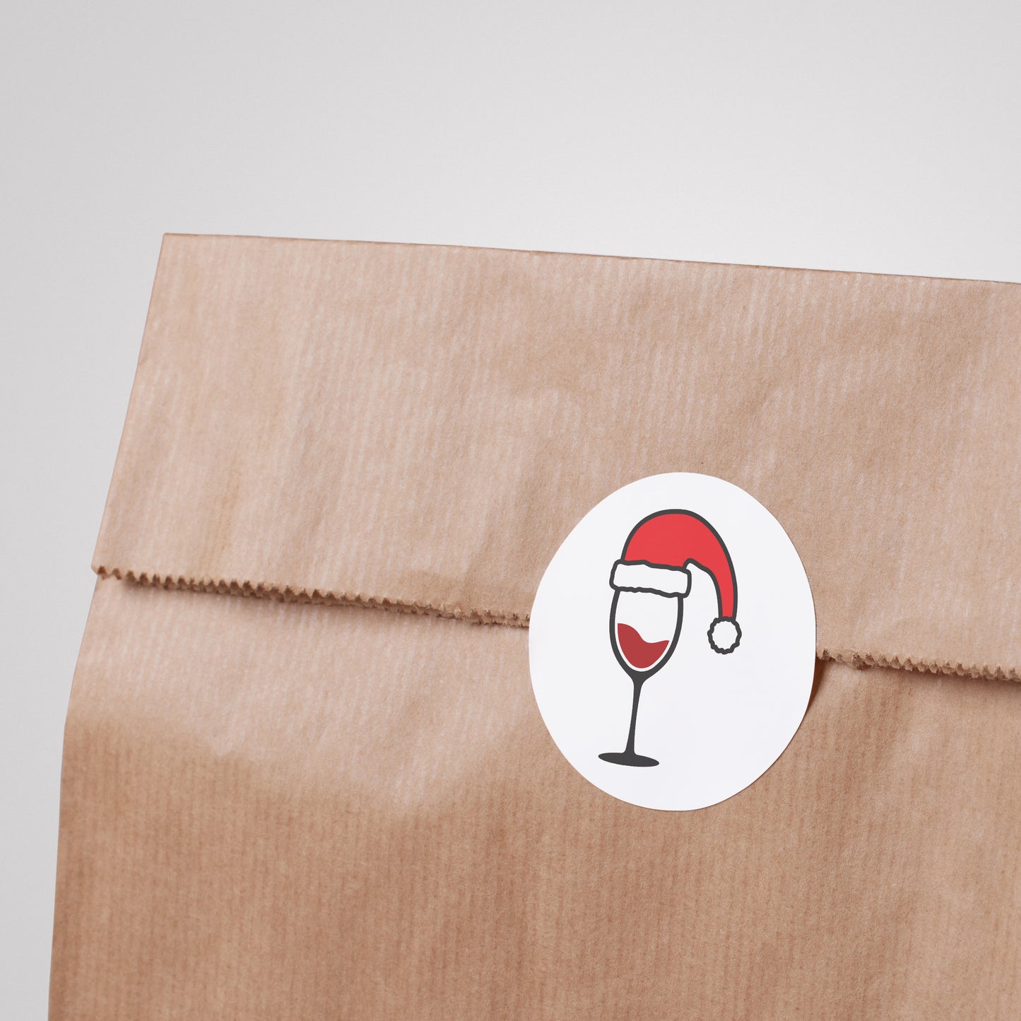 Festive wine glasses wearing Santa hats for holiday cheer