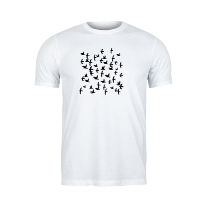 Flock of birds soaring through the sky in black silhouette