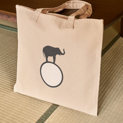 Creative elephant silhouette standing on a circular base