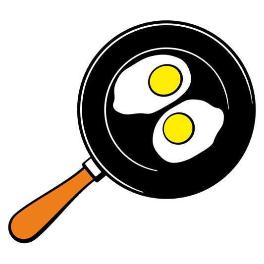 Fried eggs sizzling in black frying pan ready for breakfast