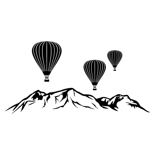Hot air balloons floating above majestic mountains at sunset