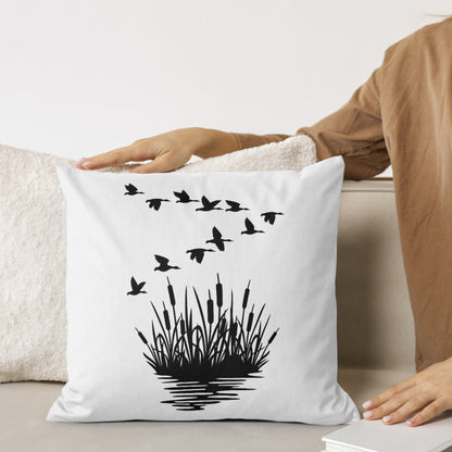 Elegant mallard ducks in flight above lush reeds